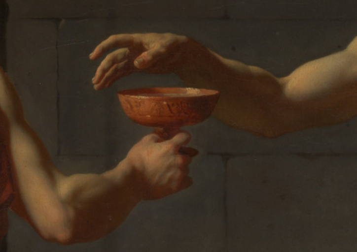 Hand being given a poisoned cup by another hand.